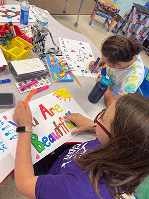 students creating colorful paper placemats