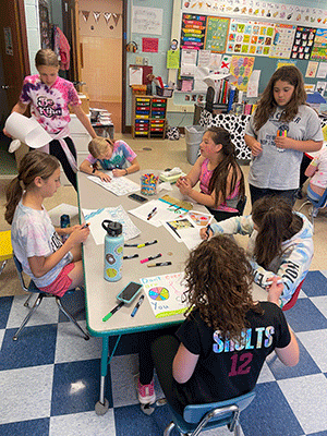 students creating colorful paper placemats