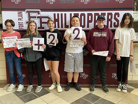 group of students holding cards saying + 22