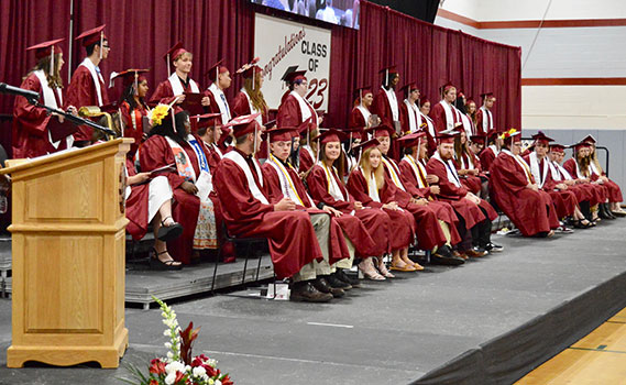 Seniors on stage at graduation, seated