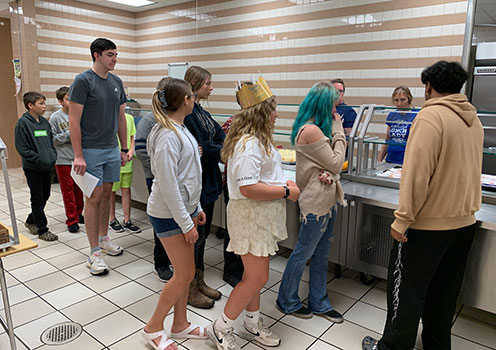 students in the cafeteria on the serving line